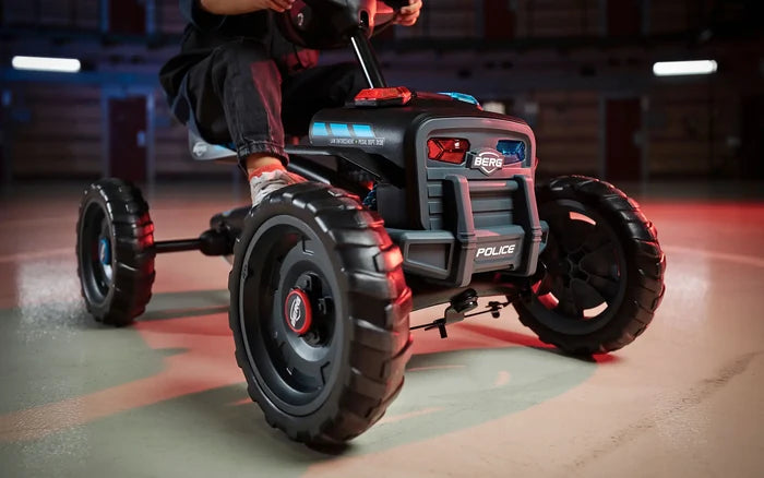 Black pedal go-kart with chunky off-road tires, red and blue lights, and a POLICE decal on the front grille.