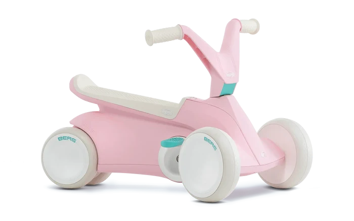 Pastel pink and white four-wheeled ride-on toy with a sleek modern body, wide white tires, and teal BERG accents.