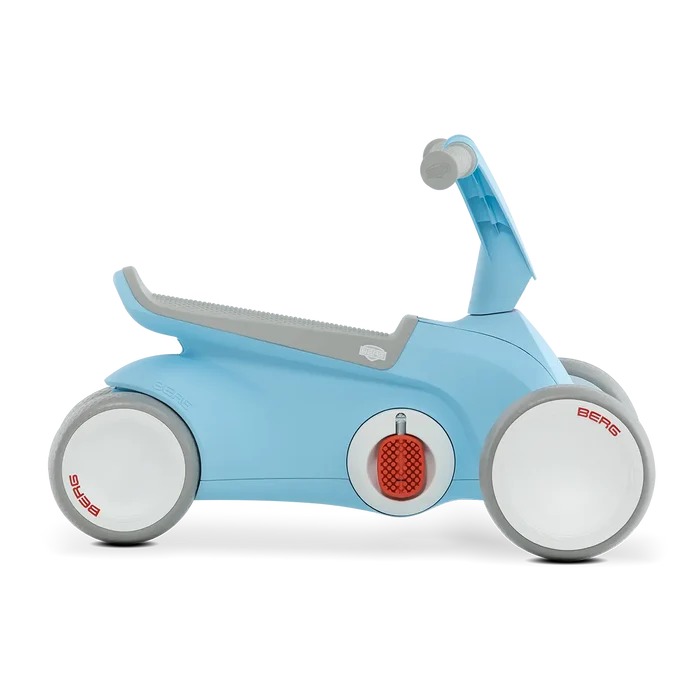 Light blue toddler ride-on with four white wheels, grey textured seat, and red fold-out pedals.
