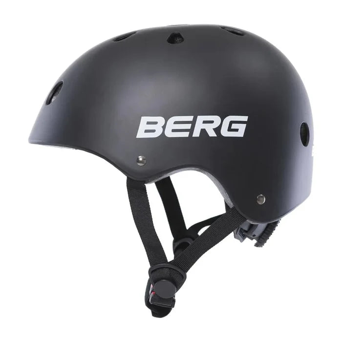 Matte black skate-style helmet with white BERG logo on side, air vents, and black adjustable chin straps.