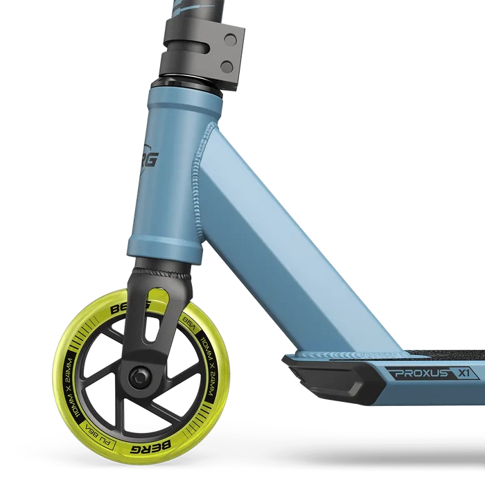 Blue trick scooter featuring a lime yellow front wheel, black fork, and Proxus X1 branding on the side.
