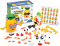 Yellow pineapple toy with interchangeable facial features, a mirror, and emotion chart next to its colorful packaging.