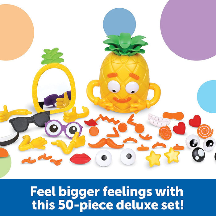 Yellow pineapple toy with a matching mirror and 50 facial expression pieces like eyes, mouths, and hands.