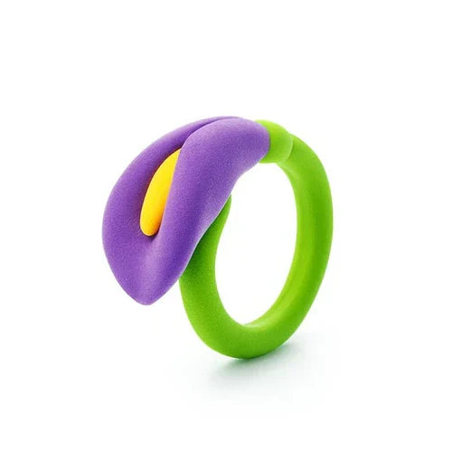 Toy flower ring featuring a purple calla lily with a yellow center on a lime green band against a white background.