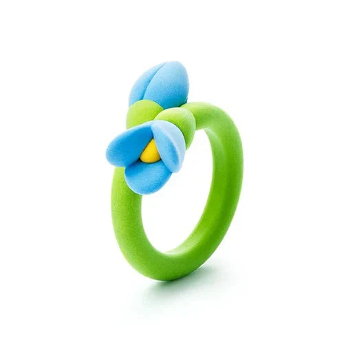 Lime green toy ring featuring a blue flower with a yellow center and a small blue bud, smooth matte finish.