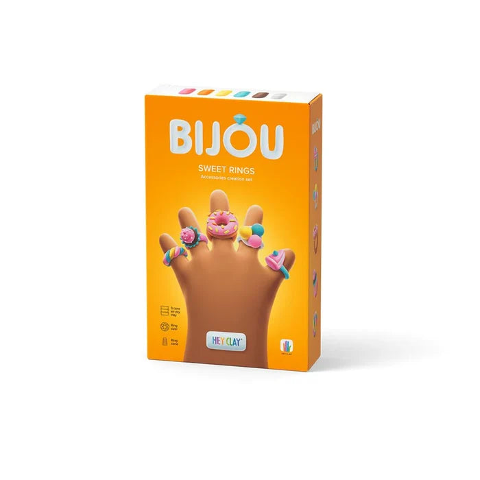 Orange box for Bijou Sweet Rings craft kit featuring a clay hand wearing colorful candy-themed rings.
