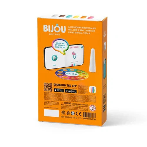 Back of an orange box showing a jewelry-making app interface, a white cone tool, and a colorful ring palette.