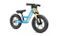 Blue balance bike with gold front forks, chunky off-road tires, and white BERG logo on the frame.