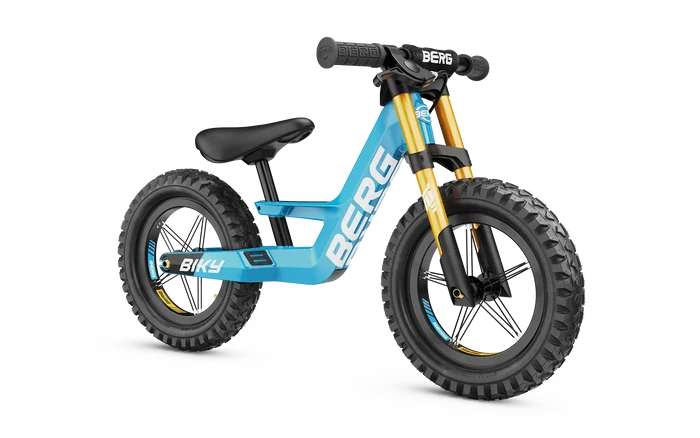 Blue balance bike with gold front forks, chunky off-road tires, and white BERG logo on the frame.
