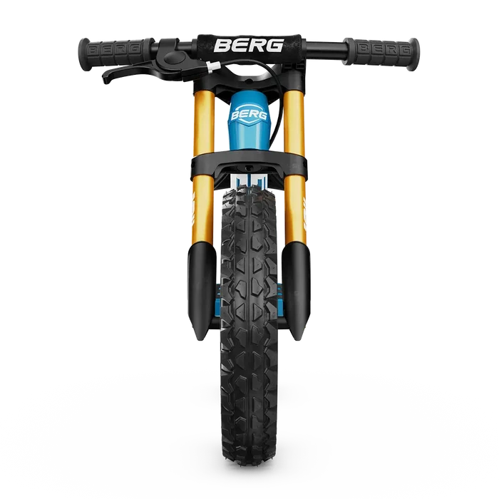 Front view of a blue balance bike with gold forks, knobby tire, and black handlebars with a handbrake lever.