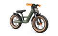 Olive green balance bike with chunky off-road tires, tan sidewalls, and orange handlebar grips.