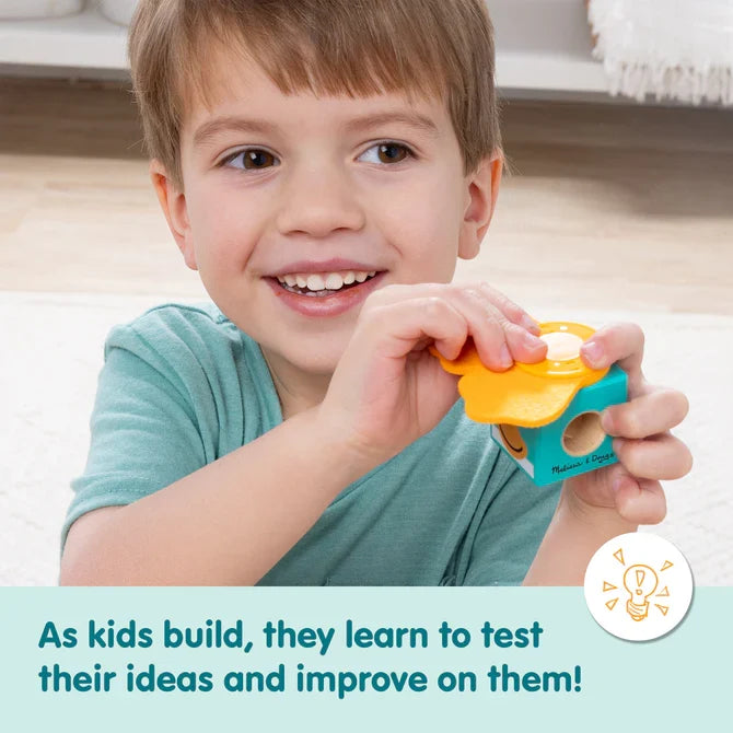 Smiling boy assembles a teal block and yellow felt. Text: As kids build, they learn to test and improve ideas.