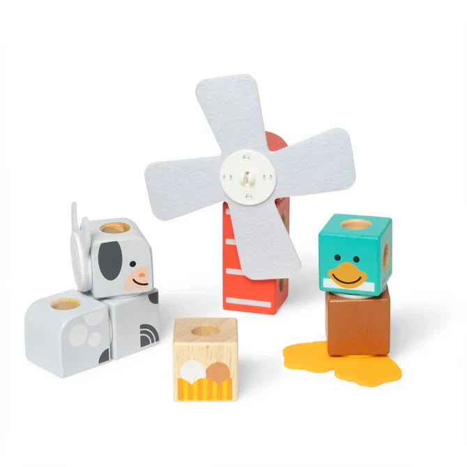 Wooden block toy set featuring a grey cow, red windmill with felt blades, and a teal duck on a white background.