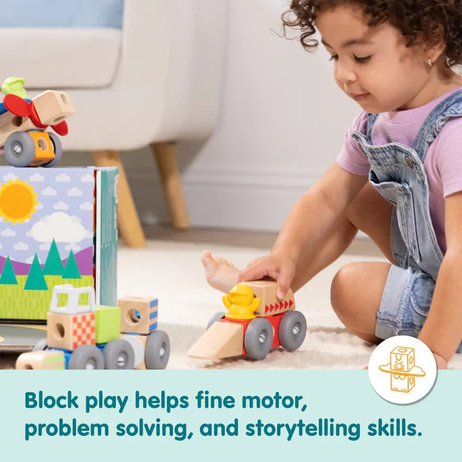Child plays with wooden block vehicles featuring wheels, primary colors, and natural wood on a neutral rug.