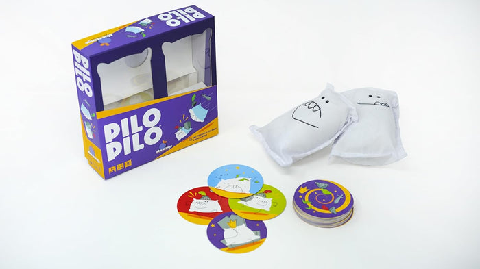 Purple Pilo Pilo game box with two small white pillows with cartoon faces and round, colorful illustrated cards.