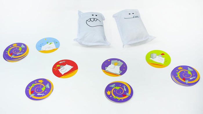 Two white plush pillows with faces and several colorful circular game cards with cartoon illustrations.
