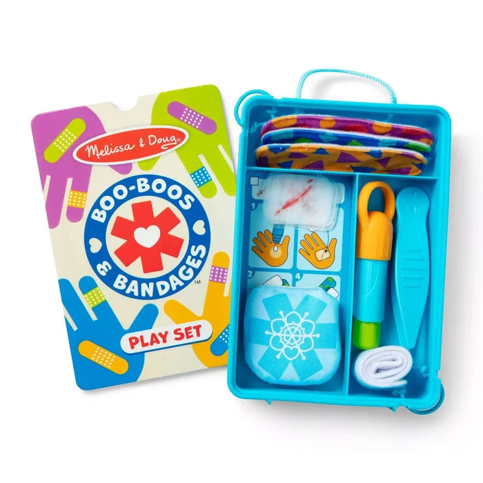 Open blue plastic first aid kit with colorful reusable bandages and tools next to its bright illustrated packaging.