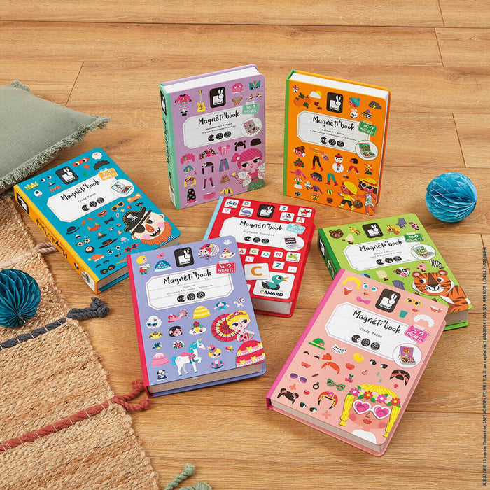 Seven colorful book-shaped magnetic toy sets with pirate and costume themes on a wooden floor.