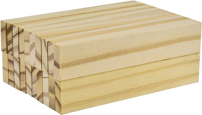 Stack of rectangular light-colored wooden planks with visible natural wood grain patterns.