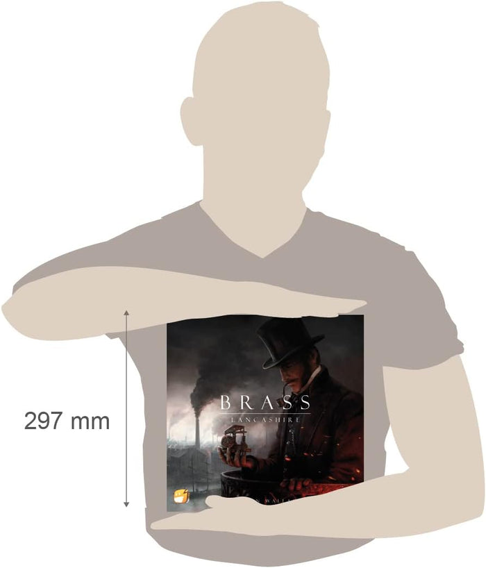 Square board game box with dark industrial artwork held by a person to show its 297 mm height.