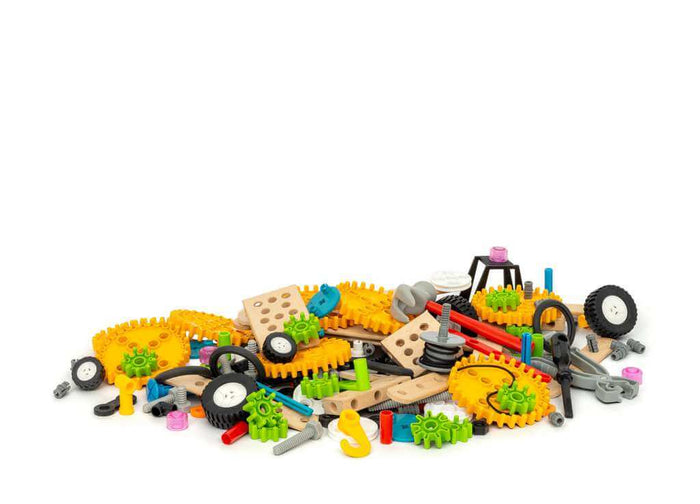 A colorful pile of toy construction pieces, including gears, wheels, and wooden blocks on a white background.
