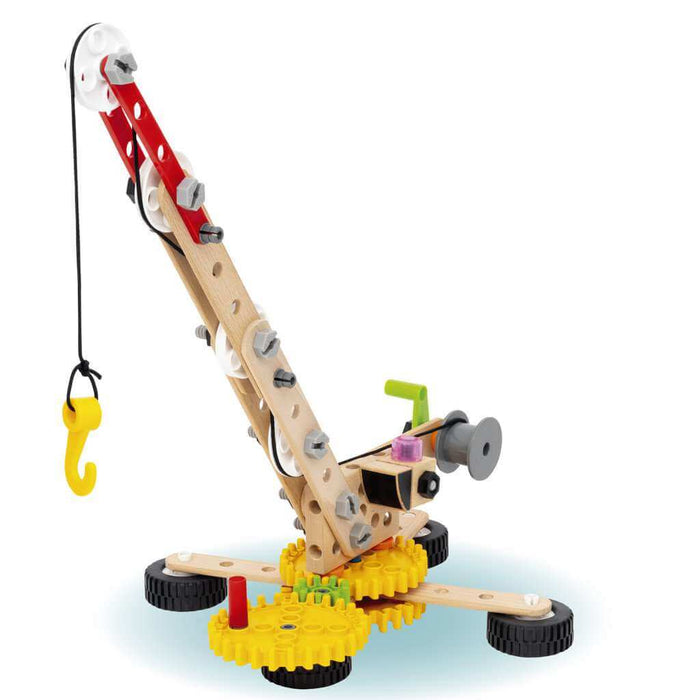 Toy crane made of wood and plastic parts with yellow gears, black wheels, and a yellow hook on a black string.