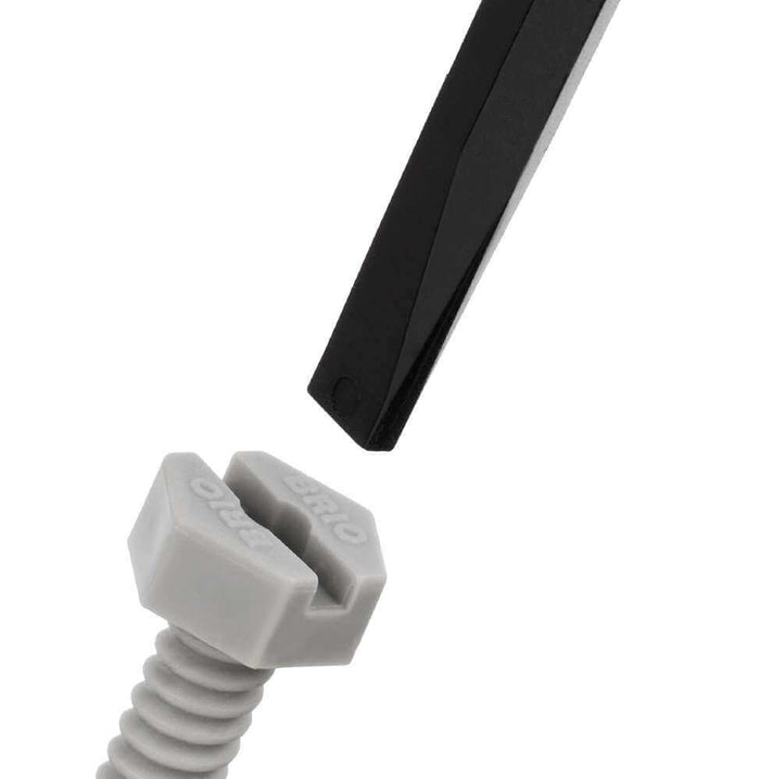 Close-up of a black toy screwdriver being used on a grey plastic hexagonal BRIO screw.
