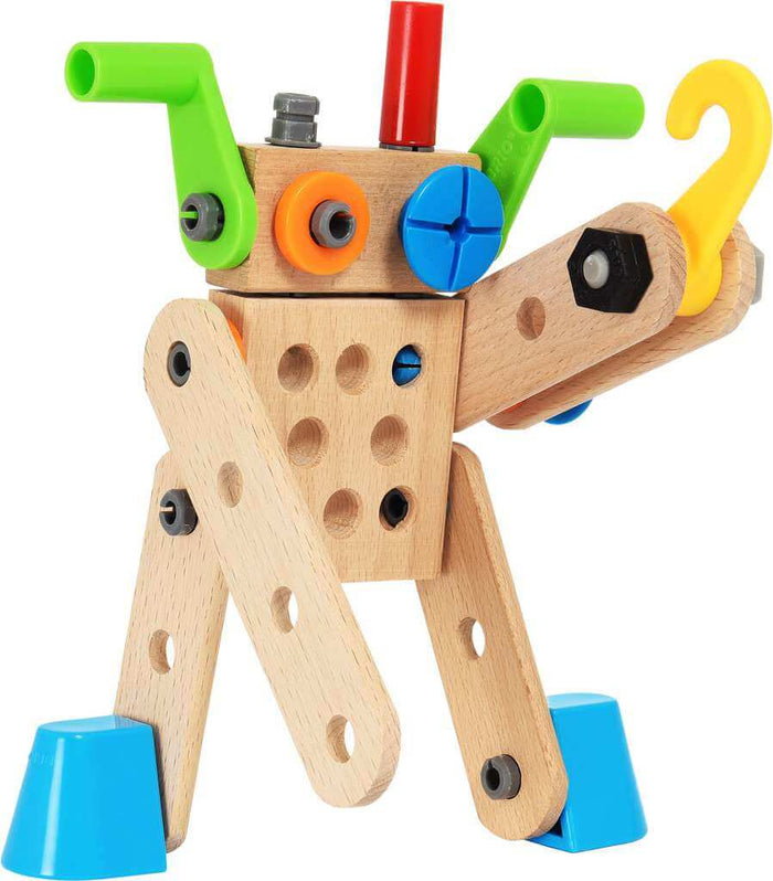 Wooden robot figure built from timber pieces with colorful plastic screws, cranks, and a yellow hook.