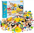 A BRIO Builder Creative Set box behind a pile of colorful wooden planks, plastic gears, wheels, and grey toy tools.