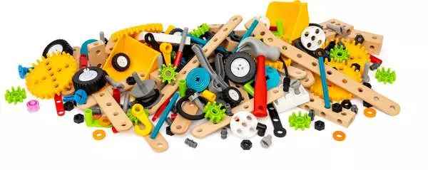 A pile of wooden slats with holes, colorful plastic gears, black wheels, and a red toy hammer.