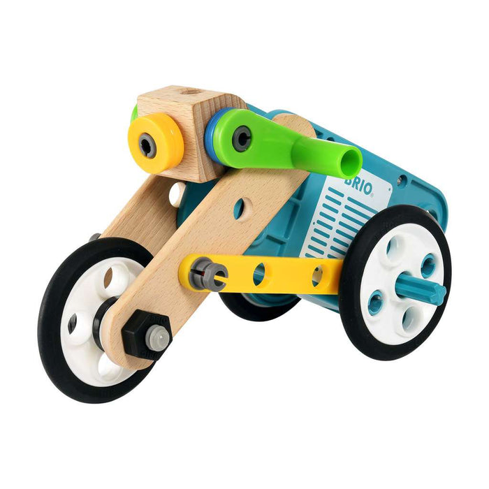 Toy motorcycle built from wood and colorful plastic with a blue motor body, three wheels, and yellow accents.