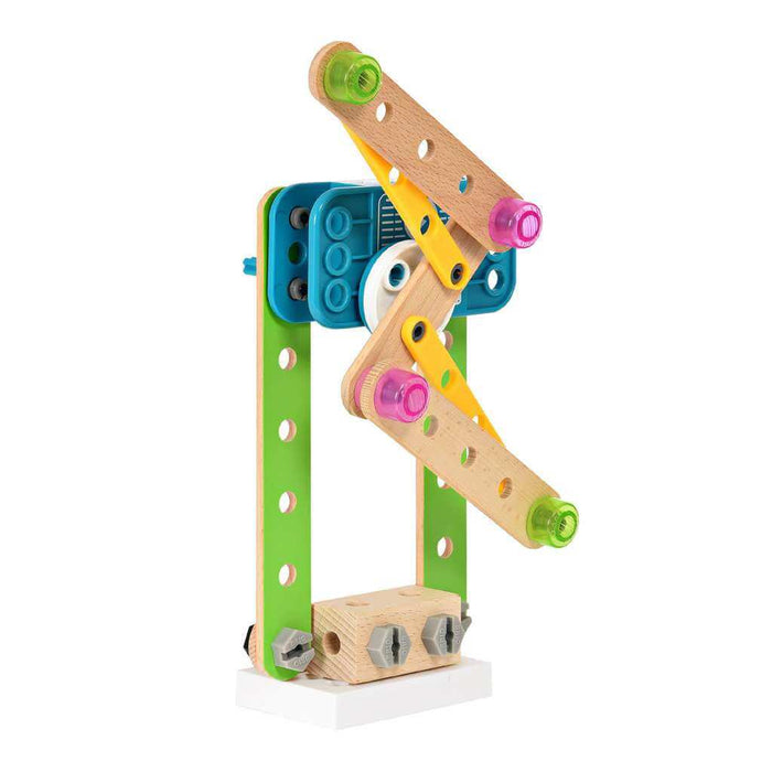 Wooden and plastic toy machine with green beams, a blue motor unit, and colorful knobs on a white square base.