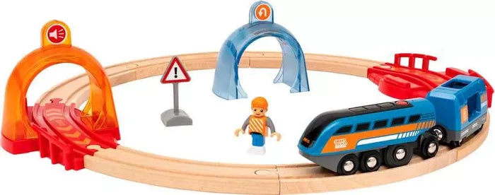 Blue toy train on circular wooden track with interactive arches, a warning sign, and a small worker figure.