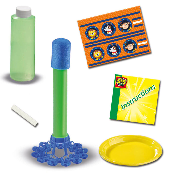 Green tube with blue foam tip, bubble ring base, animal stickers, yellow plate, chalk, bottle, and instructions.