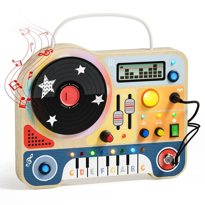 Wooden DJ busy board featuring a spinning record, piano keys, sliders, and colorful light-up buttons.