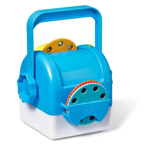 Blue and white cube projector toy with a large carry handle, star knob, and three colorful patterned disks.