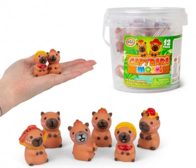 12 tiny brown capybara squishies with colorful hats in a clear tub, shown in a hand to demonstrate miniature size.