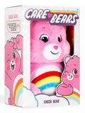 Pink plush Cheer Bear with a rainbow belly, displayed in a white and pink illustrated box.