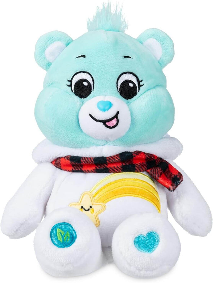 Light blue Care Bear plush wearing a white snowman hoodie with a red plaid scarf and shooting star belly badge.