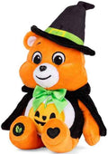 Orange plush bear in a black witch hat and cape with a green bow and a jack-o'-lantern design on its white belly.