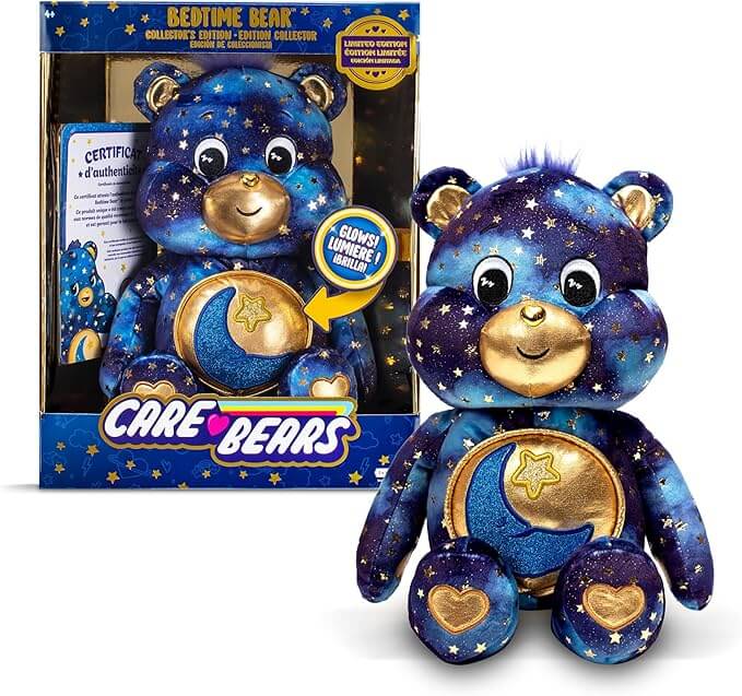 Navy blue star-patterned plush bear with gold moon belly, shown in and next to its collector edition display box.