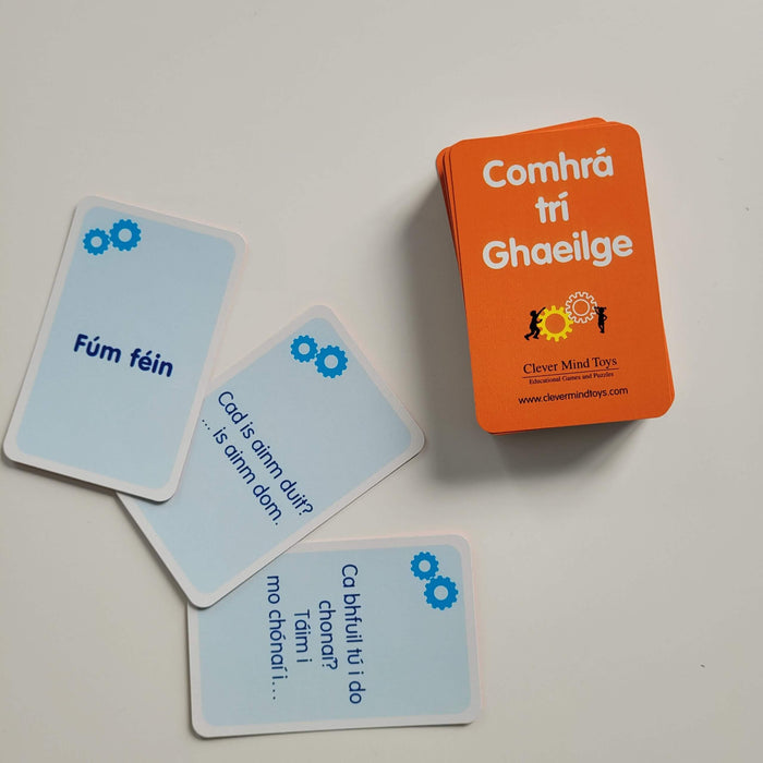 Orange deck and light blue Irish conversation cards with sample phrases and gear icons on a white background.