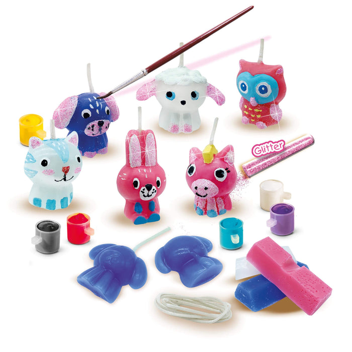 DIY candle kit with colorful animal shapes, paint pots, glitter, and wax blocks for casting and decorating figures.