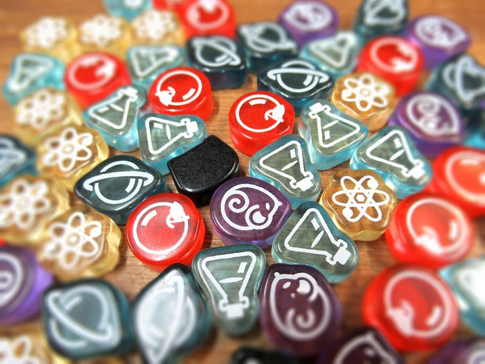 Colorful translucent tokens with white science and cat icons, featuring a solid black cat-shaped piece.