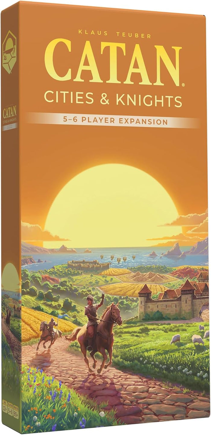 Orange Catan expansion box featuring a knight on horseback riding toward a coastal castle at sunset.