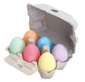 Six egg-shaped chalks in pastel green, orange, pink, blue, yellow, and purple inside a cardboard egg carton.