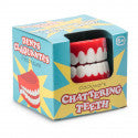 White wind-up toy teeth with red gums in a blue and yellow box with the text Chattering Teeth.