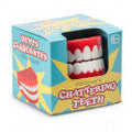 White wind-up toy teeth with red gums in a blue and yellow box with the text Chattering Teeth.