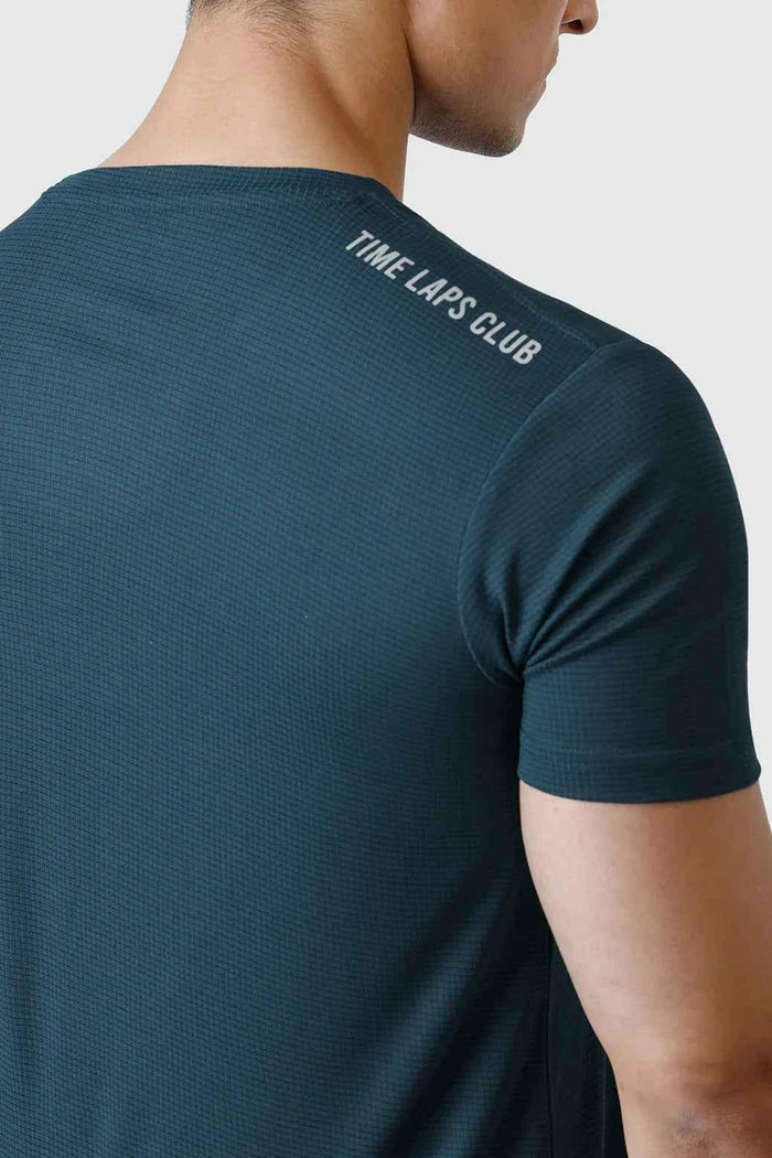 Fuaark NZ Checks Running T-shirt in bottle green, men's athletic T-shirt with checkered pattern for running and active wear.