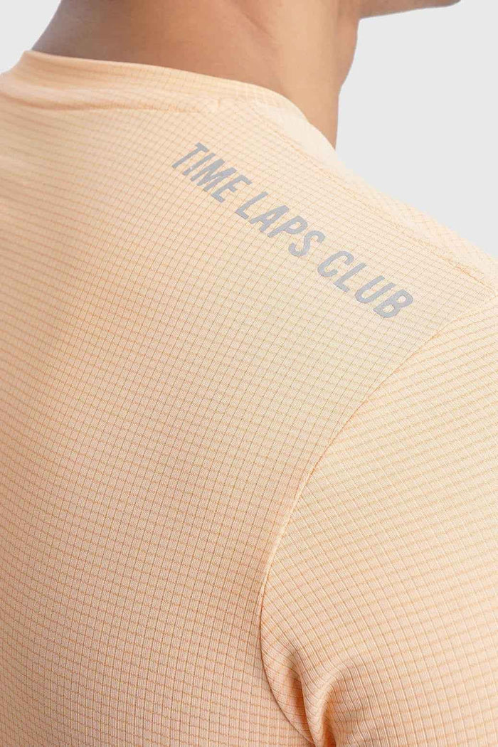 Fuaark Nz Checks Running T-shirt in peach color, featuring a casual fit and breathable fabric, designed for active wear.